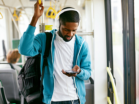Passenger listening radio headphones bus oct26_crop